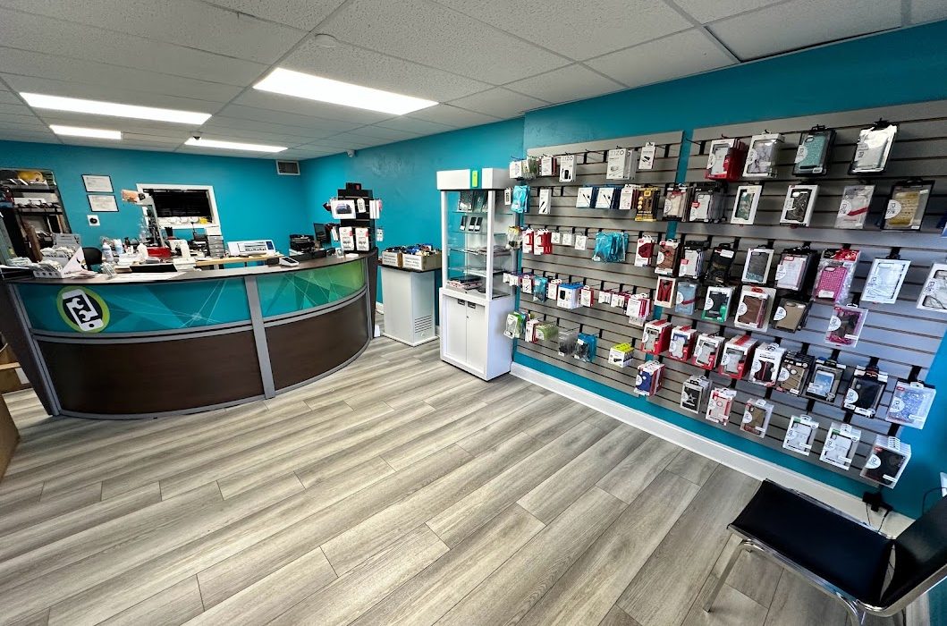 Inside Phone-Fix.com Gadget Repair: the curved service counter, teal walls and wall display of phone accessories.